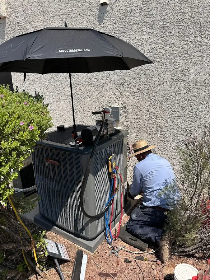 HVAC technician performing outdoor AC maintenance in Lauderdale-by-the-Sea